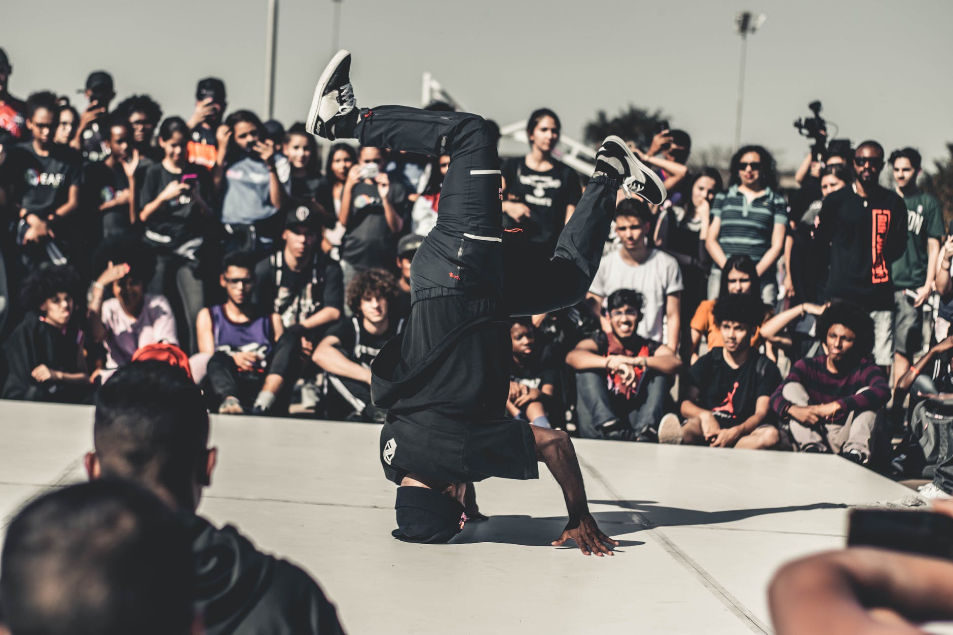 a man performing hip hop dance in front of the crowd