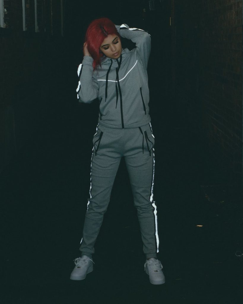 a woman posing in a tracksuit
