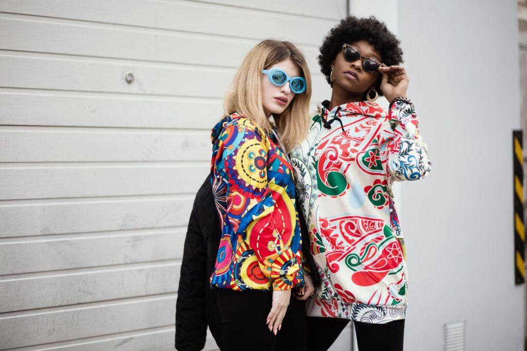 two women wearing paisley printed shirts