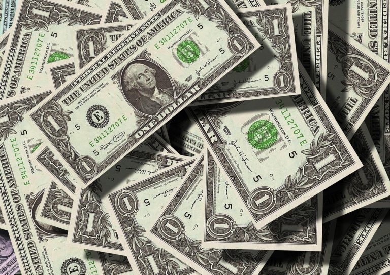 a pile of scattered dollar notes