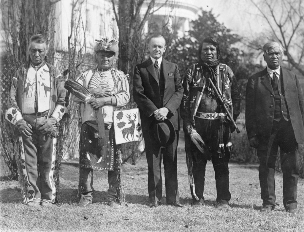 U.S. President Calvin Coolidge with four Osage Indians after signing the bill granting Indians full citizenship