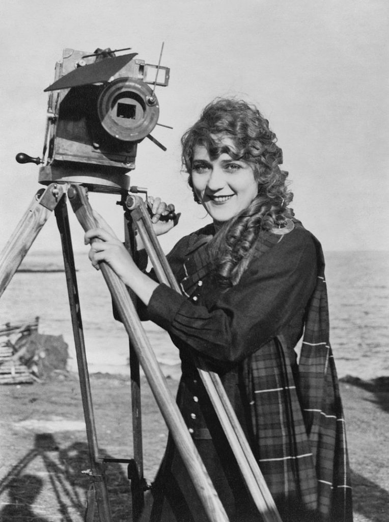 Mary Pickford holding the camera on a tripod