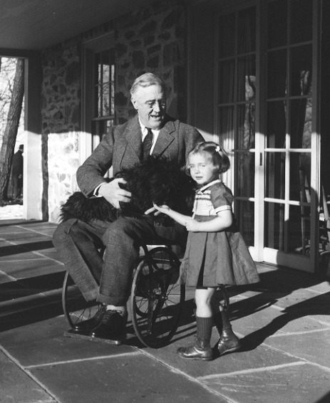 Rare photograph of Roosevelt in a wheelchair, with Fala and Ruthie Bie, the daughter of caretakers at his Hyde Park estate