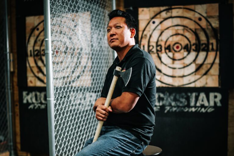 People playing axe throwing