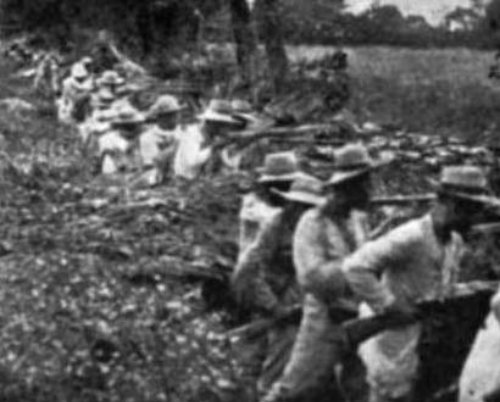 Filipino soldiers behind their trenches; photo taken in 1899, probably in Calumpit