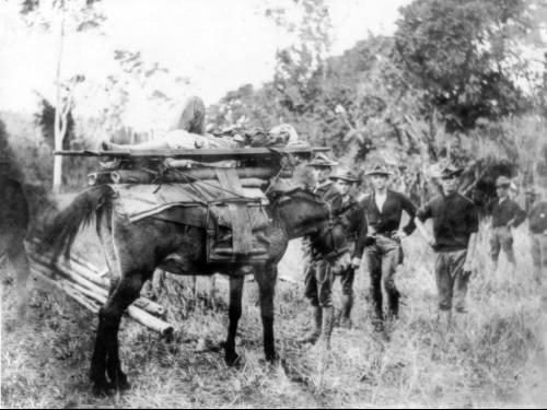 Americans transporting a wounded Filipino. [Photo was taken in 1899, somewhere in Central Luzon]