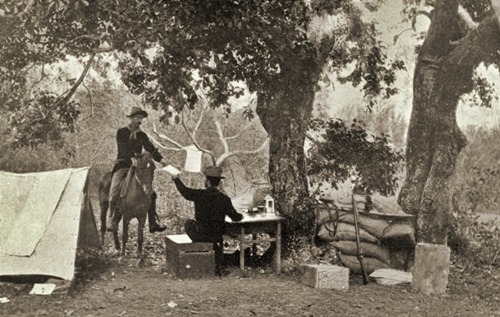 General MacArthur's orderly, Valentine (on horseback), receiving message from a signal corpsman instructing advance on the Tuliahan River, March 1899.