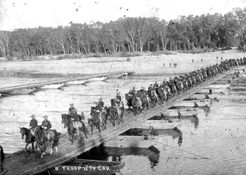 Troop B, 4th U.S. Cavalry Regiment, crossing over pontoon bridge somewhere in Central Luzon. The troop commander was 1Lt. Samuel Rutherford. Photo was taken in 1899.