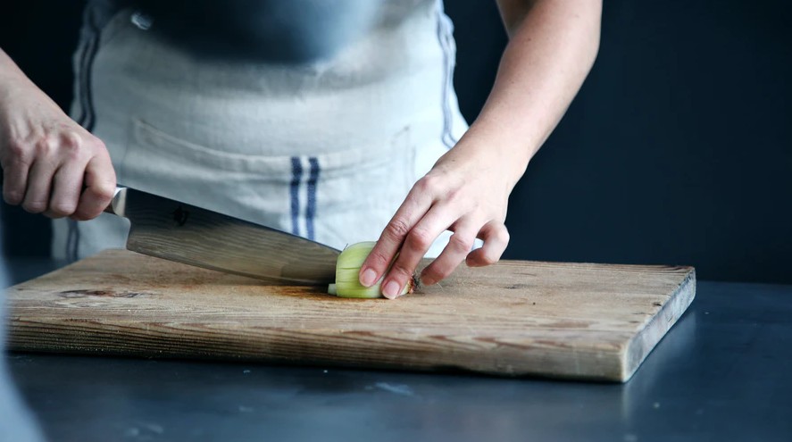 a person chopping an onion