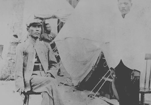 Apolinario Mabini sits outside his tent in Guam 1902