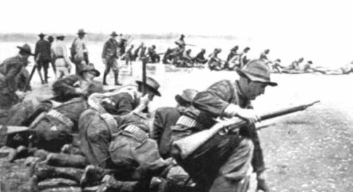 First Colorado Volunteers kneeling on beach to fire Aug 13 1898