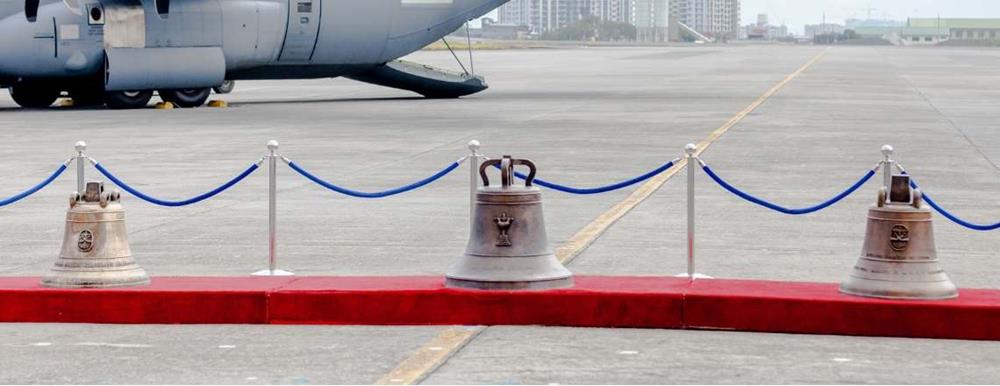 The Balangiga bells on display during a repatriation ceremony at Villamor Air Base. The left bell had been kept by the Army's 9th Infantry Regiment at Camp Red Cloud in South Korea; it is the smallest of the three. The bell in the center is the largest; it and the right-most bell had been displayed at the F.E Warren Air Force Base's Trophy Park in Cheyenne, Wyoming
