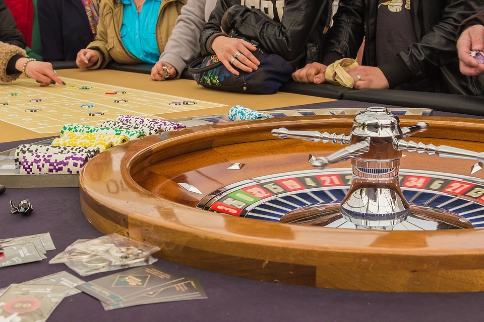 people playing roulette in a casino