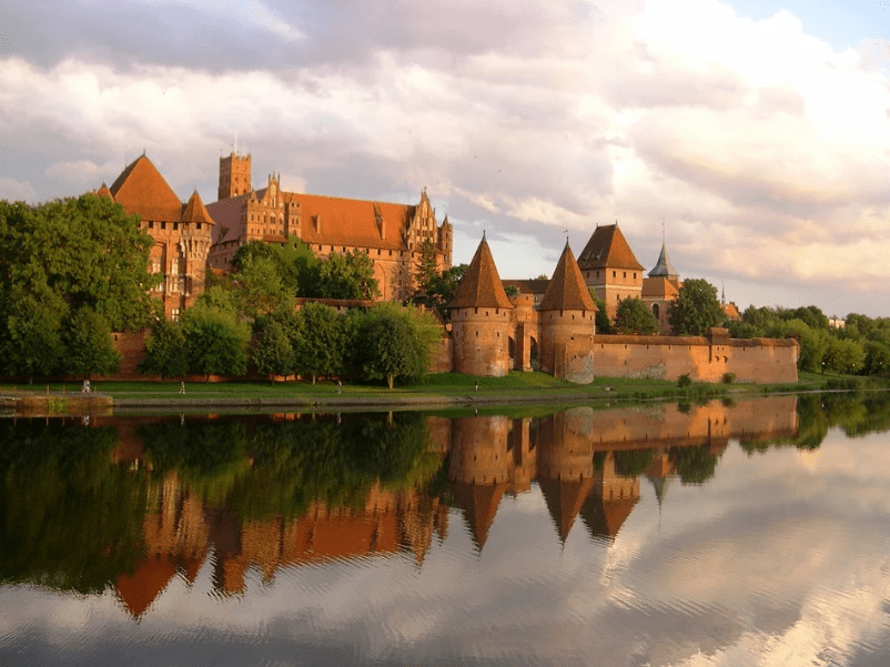 Malbork Castle mirrored by a lake