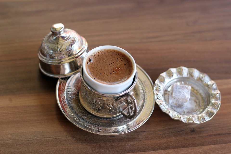 a cup of Turkish coffee served with a Turkish delight