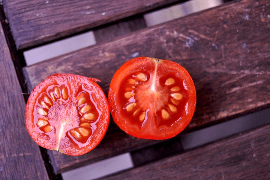 halved tomato with seeds showing
