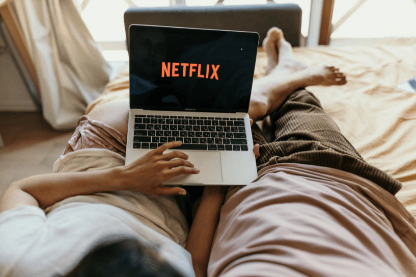 a couple watching Netflix on their laptop