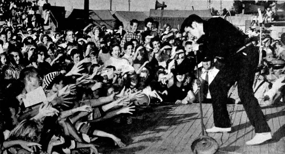 Elvis Presley performing in front of a crowd