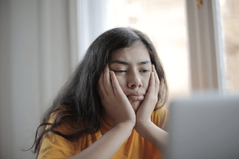 melancholic-woman-watching-video-on-laptop-at-home