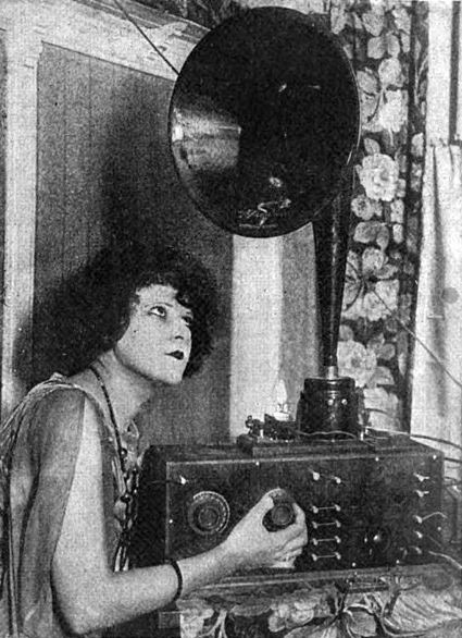 woman listening to a radio in 1923