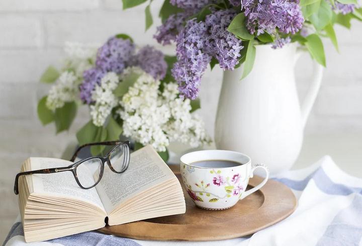 A book with glasses and flowers