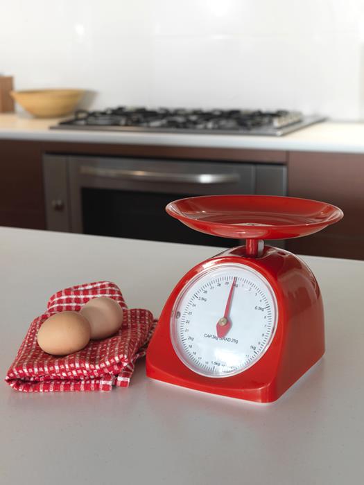 Eggs beside a mechanical kitchen scale