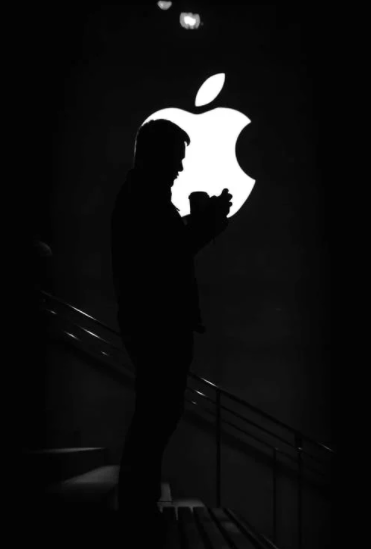 The Apple logo with a person’s silhouette in front