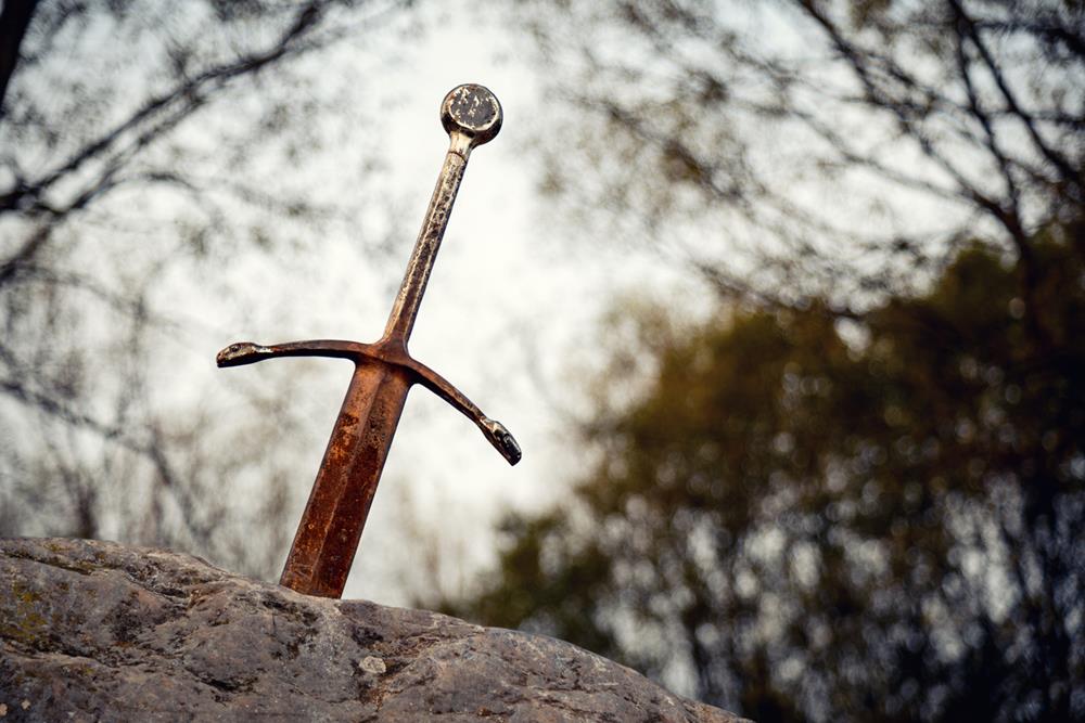 Excalibur the famous sword in the stone of king Arthur in the forest