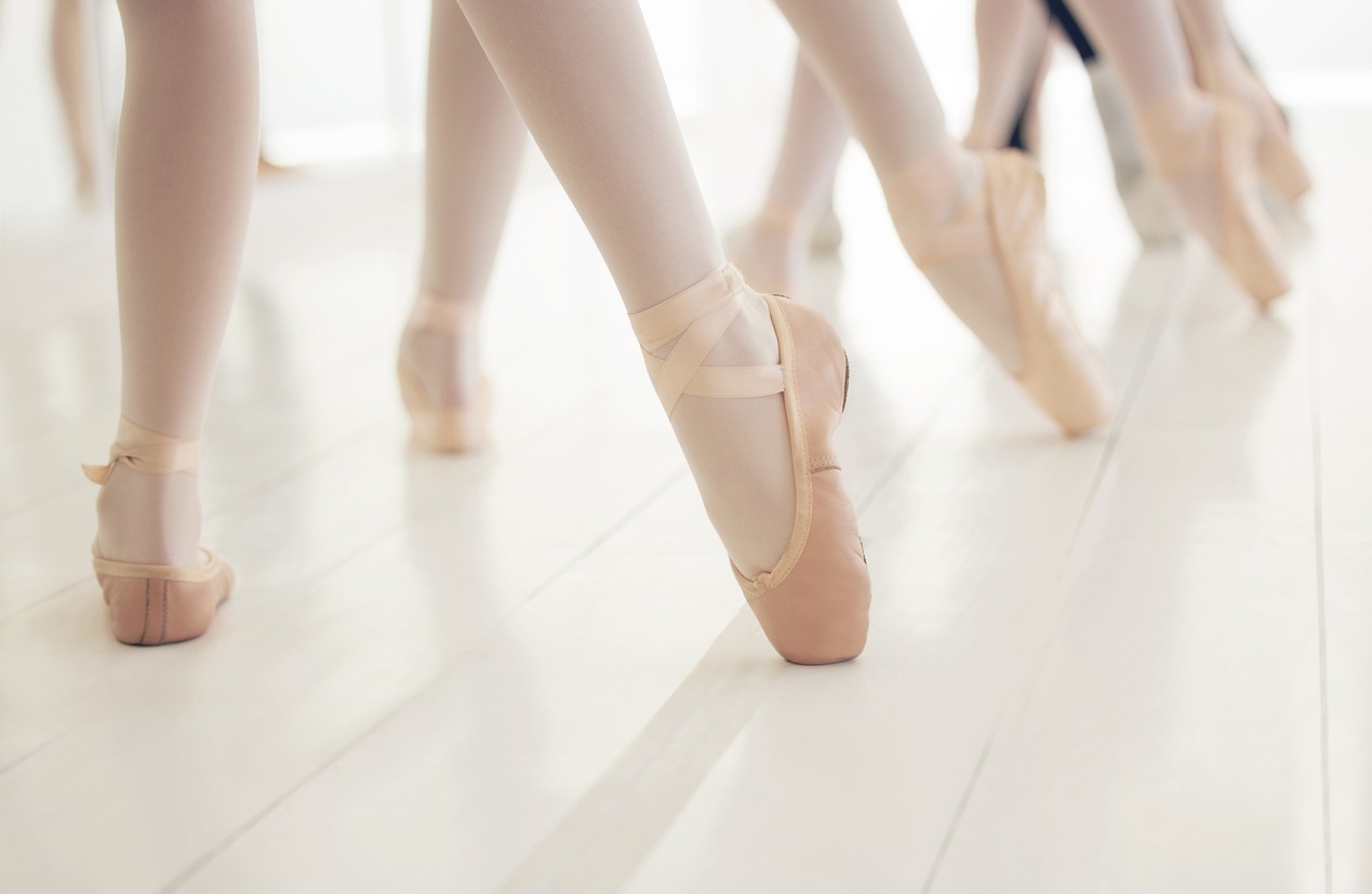 Shot of a group of unrecognizable ballet dancers during their rehearsal in a studio