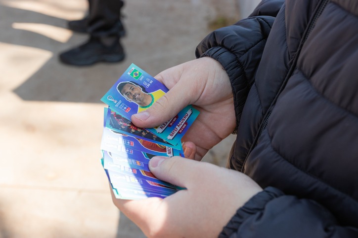 Parents and children passionate about soccer exchange stickers from the Panini album