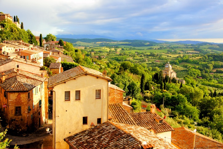 Sunset view of a town overlooking countryside of Tuscany, Italy