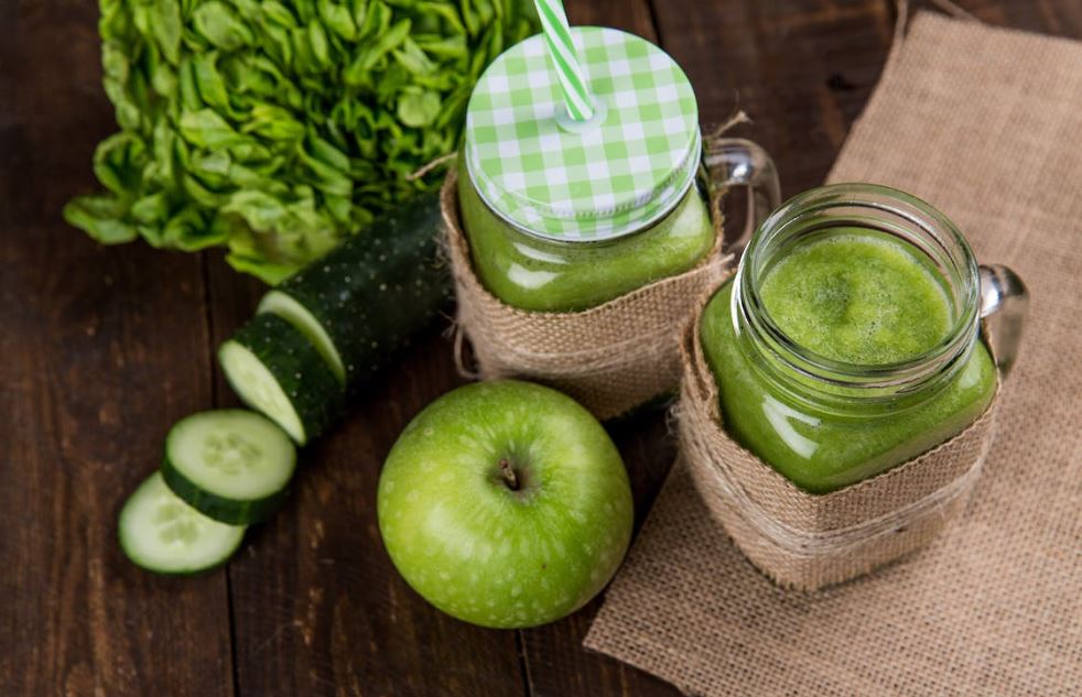 green apple beside of two clear glass jar