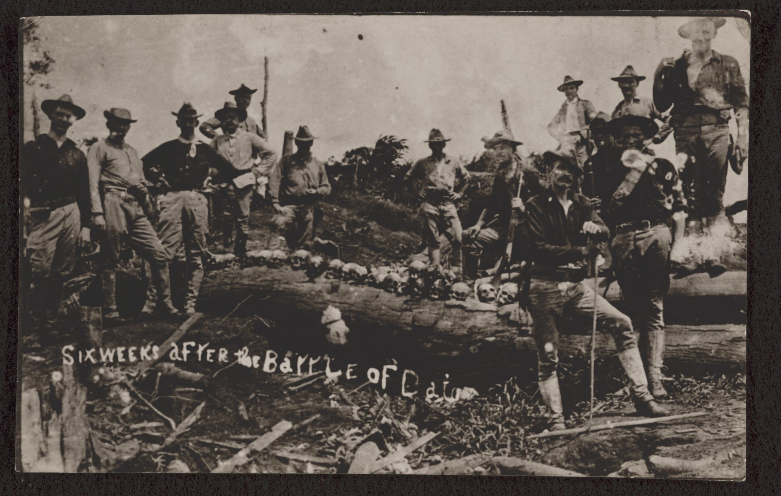 Soldiers displaying skulls after a battle in the Philippines
