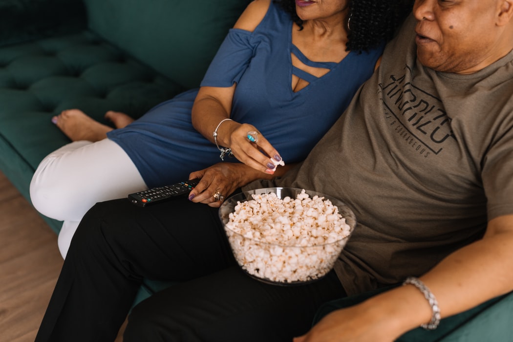man-and-woman-eating-popcorn-watching-tv