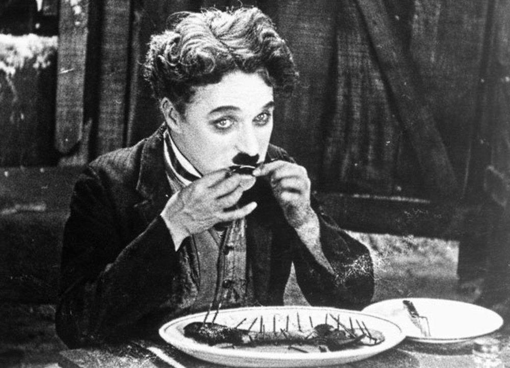 The Tramp resorts to eating his boot in The Gold Rush (1925)