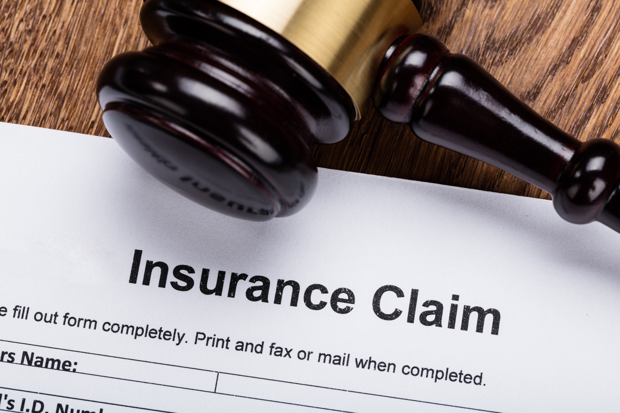 Wooden Gavel On Insurance Claim Form