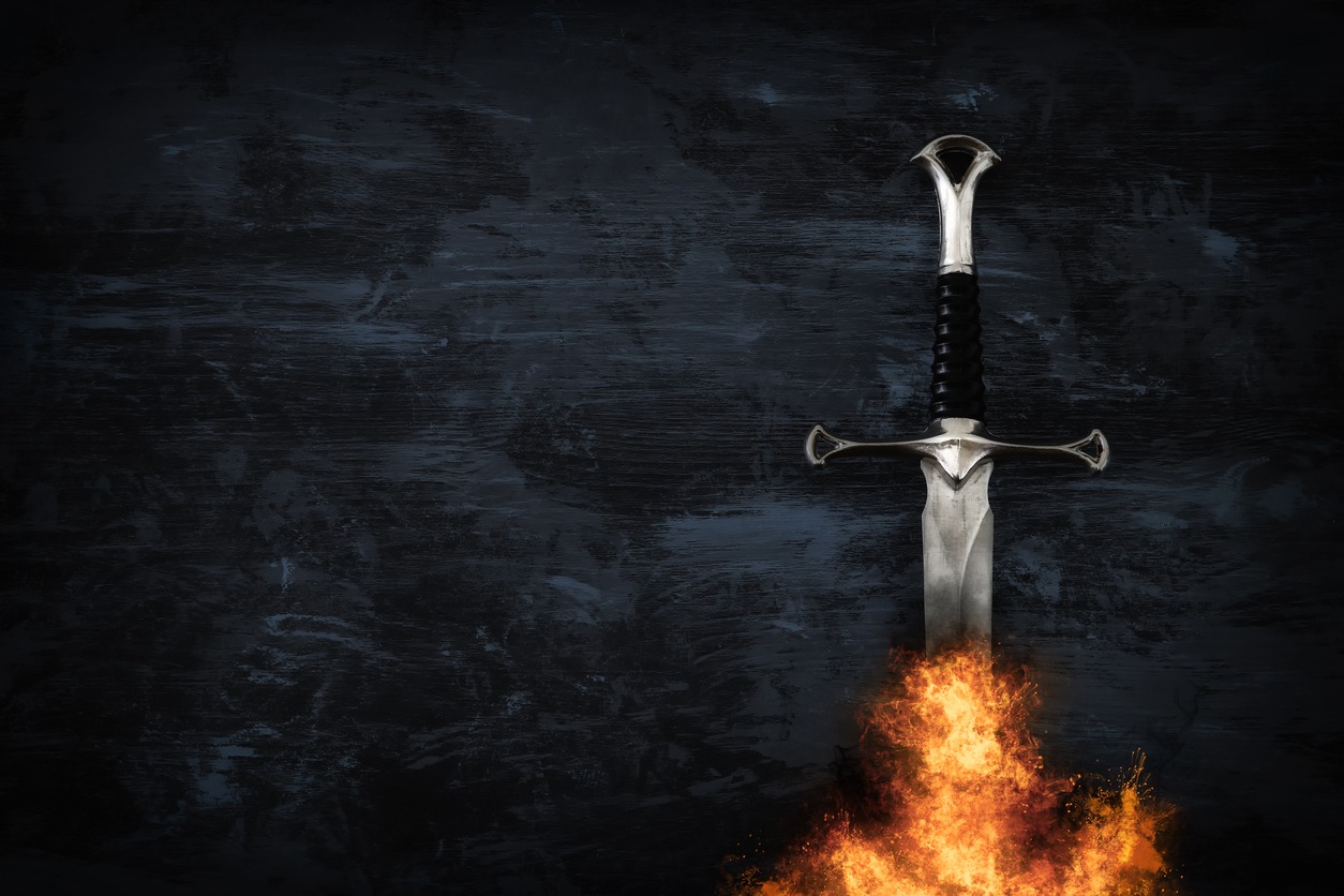 image of silver sword in the flames of fire