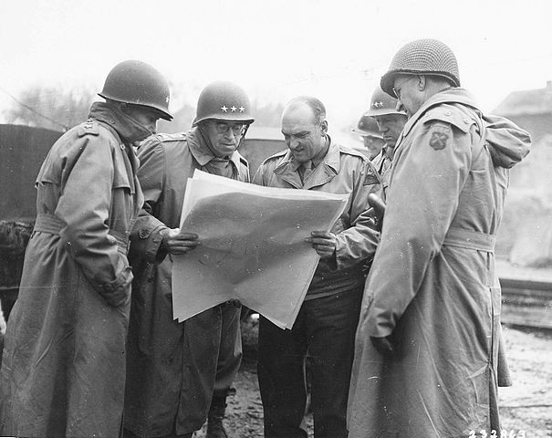 George Patton looking at a map with other generals