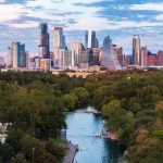 Aerial view of the Austin skyline at sunset over Barton Springs