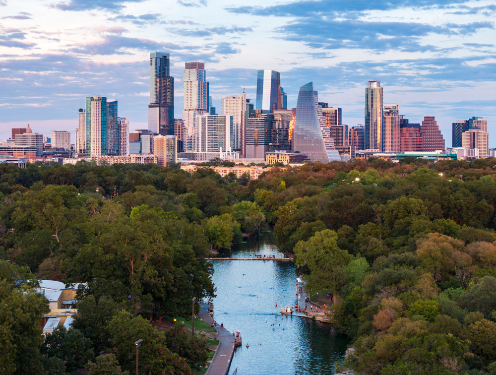 Aerial view of the Austin skyline at sunset over Barton Springs